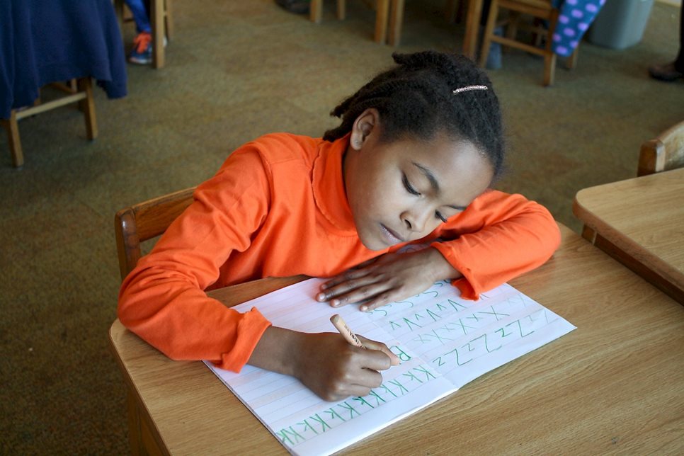 Girl learning to write