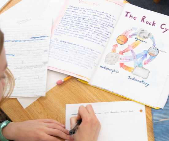 Student at Waldorf school working on illustrated notebook assignment